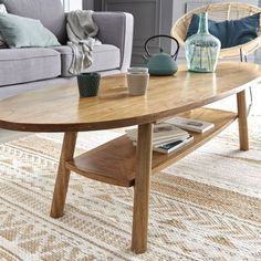 a living room with a couch, coffee table and two vases on the floor