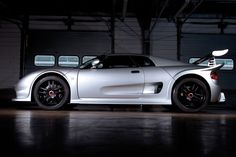 a silver sports car parked in a garage