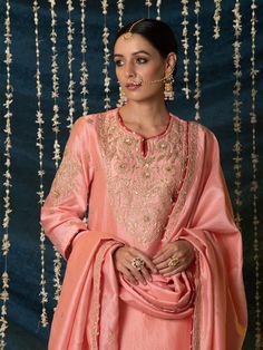 "Jashn-E-Ulfat" - a collection of ensembles that evoke a sense of majestic opulence and modern royalty. Suffused with deep rich hues set on plush cotton silk enhanced with remarkable craftsmanship like Marodi, Mirror and Zardozi embroidery, each ensemble has a romantic and feminine charm of its own collection. This set of 3 consists of a Kurta, Salwar and Dupatta. Kurta: This dainty peach chanderi silk kurta is enhanced with handcrafted zardozi, sitara and zardozi jaal work on the neck, buttas o Plain Suits, Embroidery Zardozi, Silk Kurta Set, Modern Royalty, Traditional Attires, Zardozi Embroidery, Silk Kurta, Silk Suit, Pretty Patterns