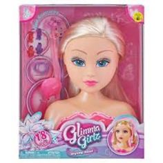 a doll with blonde hair and blue eyes in a pink package on a white background