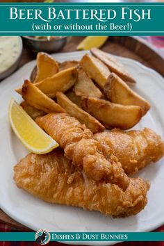 fish and fries on a white plate with lemon wedges next to the caption beer battered fish with or without the beer