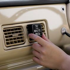 a person pressing the button on an old car