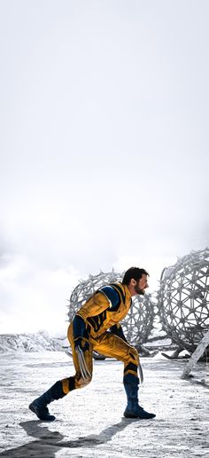 a man is running in the snow near a structure that looks like a bird's nest