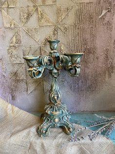 an ornate blue and gold candle holder on a table