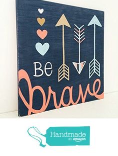 a wooden sign that says be brave with arrows and hearts on the front, hanging on a wall