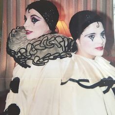 an old photo of two women dressed in black and white costumes, one with makeup on her face