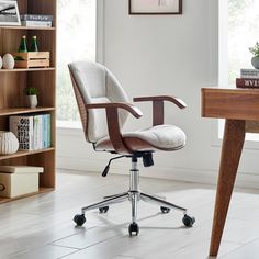 an office chair sitting on top of a wooden desk next to a book shelf and bookshelf