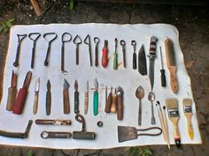 an assortment of tools are laid out on a white sheet and placed next to each other