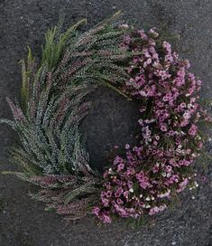 a wreath made out of purple flowers on the ground