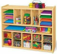 a wooden shelf filled with lots of books and crafting supplies on top of it