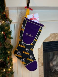 a christmas stocking hanging on the wall next to a fireplace