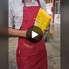 a man in an apron is holding a box