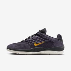 the nike air zoom running shoe in dark purple and gold is on sale for $ 99