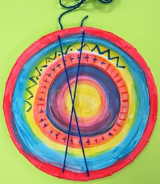 a colorful paper plate with yarn on it and a piece of string hanging from the top