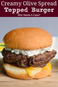 a cheeseburger is shown with the words, creamy olive spread topped burger who needs a caper?