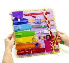 a person holding up a colorful board with lots of different items on top of it