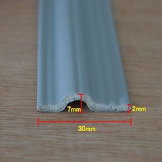 the width of a plastic window seal on a wooden surface with measurements for each section