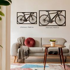 a living room with two bikes on the wall and a coffee table in front of it