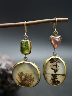 “The Inferno is not only a dreamlike space, but a place of symbols.” - Dante's Divine Comedy The pièce de résistance of the Inferno Collection. This incredible mismatched pair are truly works of art to adorn your body with. Two mismatched tourmaline stones hang from 18k gold hooks. Beneath them dangle a mismatched, though perfectly balance, pair of dendritic agate stones that are pieces of art in their own right. The stones are all lovingly wrapped in deliciously warm 18k gold and this pair simp Hand Forged Jewelry, Divine Comedy, Bold Statement Jewelry, Ancient Jewellery, Gold Hooks, Reiki Jewelry, Hot Jewelry, Mismatched Earrings, Dendritic Agate