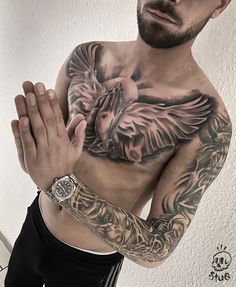 a man with tattoos on his chest and arm