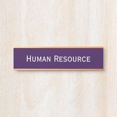 a wooden sign that says human resources on the front and back of it in purple