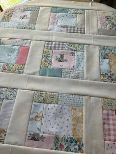 a quilted table runner made out of patchwork fabric