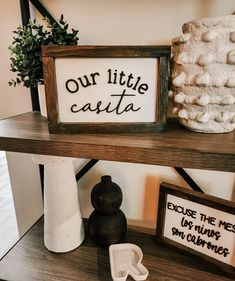 a shelf with some items on it and a sign that says our little castea