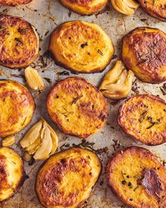 baked potatoes with herbs and seasoning on a baking sheet