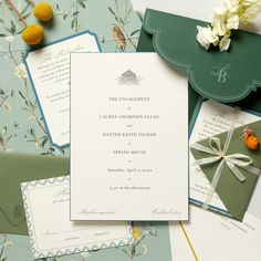 the wedding stationery is laid out on top of each other