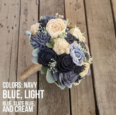 a bridal bouquet on a wooden floor with the words colors navy, light blue, state blue and cream