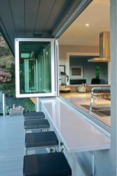 a long counter top sitting under a kitchen window