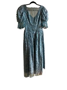 1970's vintage JCPenny Fashions blue lace gown. Size small to extra small. Lovely princess vibes. Excellent condition. Good for costumes or part wear. Really pretty for the holidays. Marked a vintage size 7/8 but by our standards it's smaller. 31 inch bust. 26 to 27 inch waist. Arm 17 inches. Length 50.5 inches. Hip 46 inches. However, the hip is meant to hang loose. Blue Vintage Dress For Costume, Blue Vintage Costume Dress, Fitted Blue Vintage Dress For Wedding, Blue Vintage Dress With Fitted Bodice, Blue Fitted Vintage Dress For Vintage Occasions, Blue Vintage Dress For Vintage Events, Blue Vintage Evening Dress, Blue Vintage Dress For Wedding, Vintage Blue Dress With Lace Trim