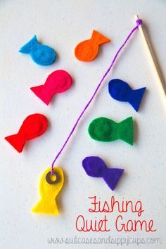 colorful felt fish game on a white surface with an orange stick and some other items