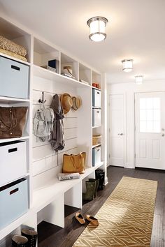 White entryway cabinet for shoe cabinetry
​Clear and organized cabinetry looks very modern and simple. Dark brown wood floor and white cabinetry create nice soft contrast together.