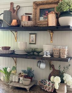 the shelves in the kitchen are filled with dishes and vases on top of them