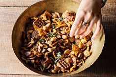 a person reaching for some food in a bowl