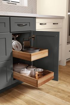 an open drawer in the middle of a kitchen