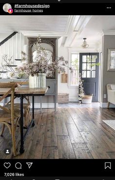 a dining room with wooden floors and white walls