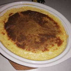 an omelet is sitting on a plate on the counter top, ready to be eaten