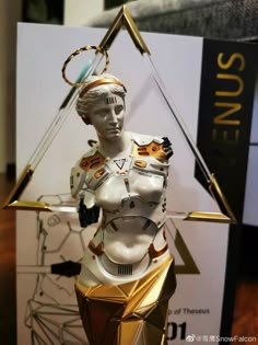 a white and gold statue is on display