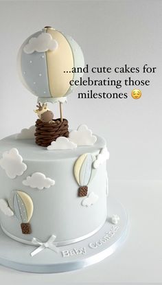 a birthday cake with a hot air balloon on top that says, and cute cakes for celebrating those milestones