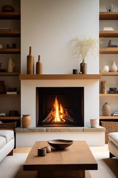 a living room filled with furniture and a fire place in the middle of the room