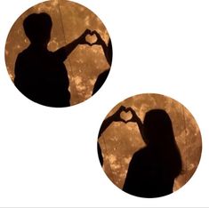 two silhouettes holding hands in the shape of a heart against a full moon background