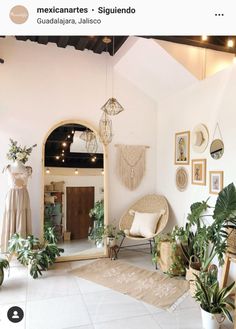 a living room filled with lots of furniture and plants on the floor next to a mirror