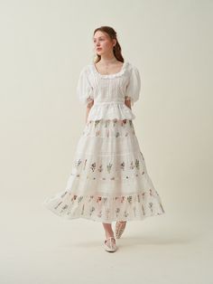 Embark on a poetic journey with our exquisite linen skirt, meticulously adorned with the essence of romance - embroidered floral. Each petal and leaf is carefully sewn to bring the skirt to life, adding a touch of whimsy and romance to the overall design.  This multi-colored skirt will transports you to a secret garden, where flowers of every colorbloom in resplendent glory. With each step you take, you'll feel as if you're walking through a dreamlike forest, the birds fluttering around you, wea Tiered Maxi Skirt For Garden Party, Relaxed Tiered Maxi Skirt For Garden Party, Feminine Midi Length Skirt For Garden Party, Feminine Tiered Maxi Skirt For Garden Party, Tiered Gathered Maxi Skirt For Garden Party, Voluminous Tiered Skirt For Garden Party, Spring Floral Embroidered Full Skirt, Spring Full Skirt With Floral Embroidery, Elegant Cotton Skirt With Floral Embroidery