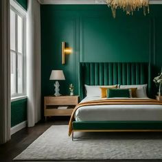 a bedroom with green walls and gold accents