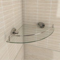 a glass shelf in the corner of a shower stall with a towel bar attached to it