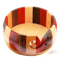 a wooden bowl that is shaped like an elephant's tail and has stripes on it