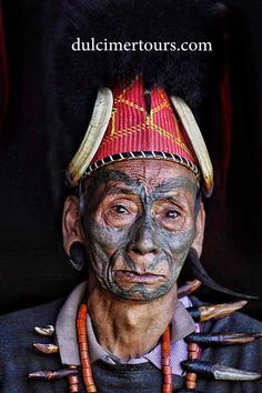 an old man with painted face and headdress