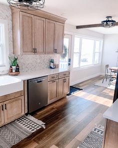 a kitchen with wooden cabinets and white counter tops